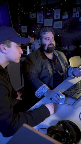Remy DeCausemaker working with another student in front of a computer.